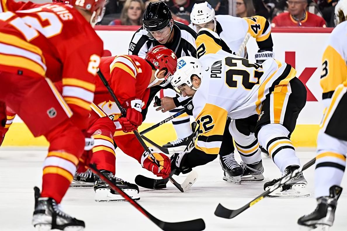 CALGARY, AB - OCTOBER 25: Calgary Flames Center Mikael Backlund (11) and Pittsburgh Penguins Winger Sam Poulin (22) take a face-off during the third period of an NHL game between the Calgary Flames and the Pittsburgh Penguins on October 25, 2022, at the Scotiabank Saddledome in Calgary, AB. (Photo by Brett Holmes/Icon Sportswire via NHL/Getty Images)