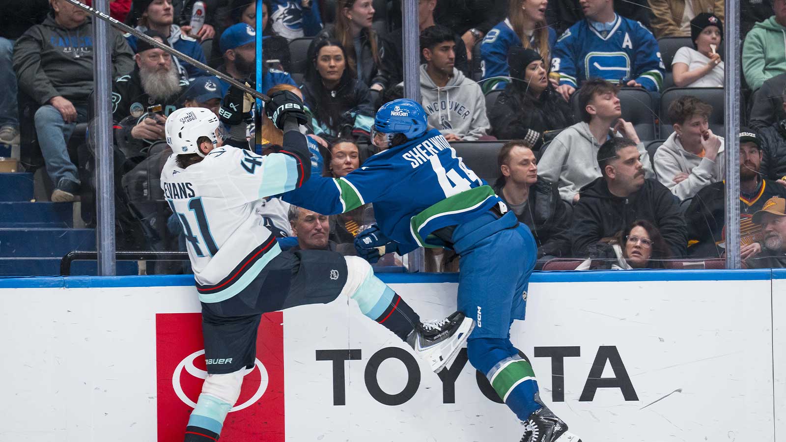 Vancouver Canucks forward Kiefer Sherwood (44) checks Seattle Kraken defenseman Ryker Evans (41) in the second period at Rogers Arena.