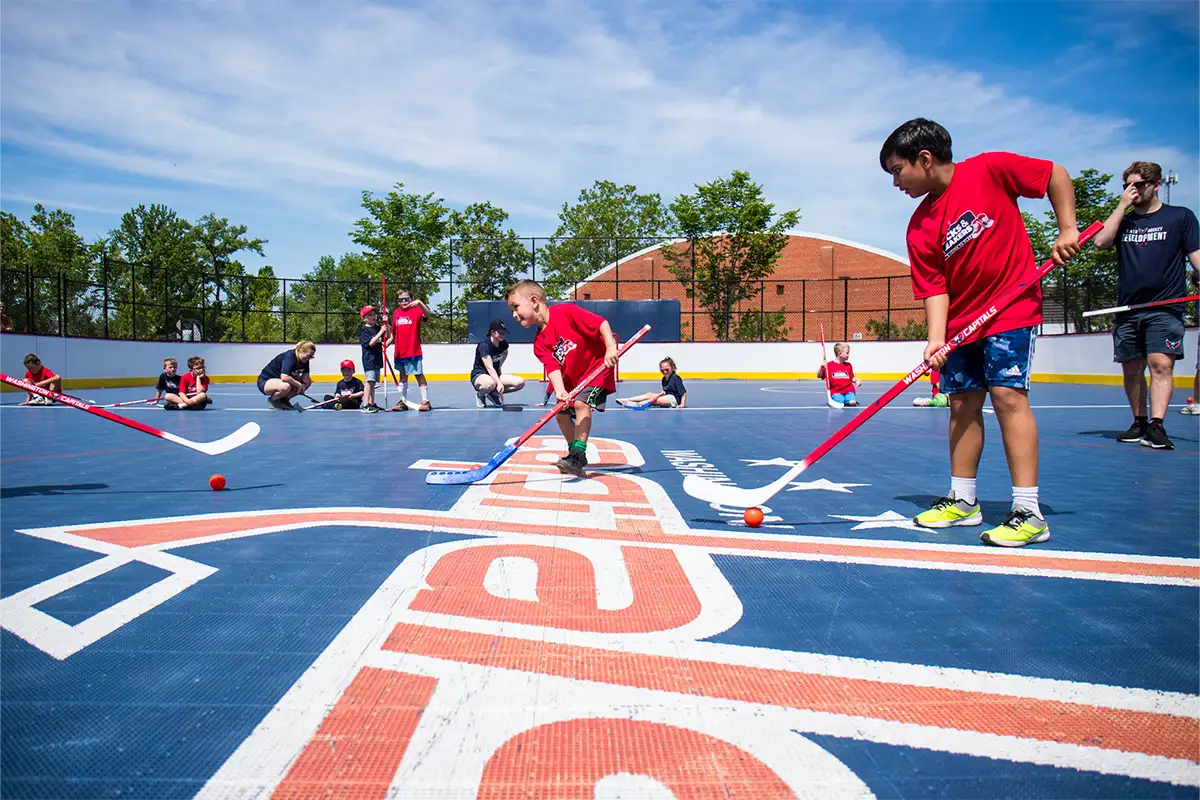 kids playing street hockey with Washington Capitals logo
