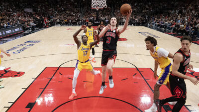 Mar 27, 2025; Chicago, Illinois, USA; Los Angeles Lakers forward Dorian Finney-Smith (17) defends Chicago Bulls guard Josh Giddey (3) during the second half at United Center.