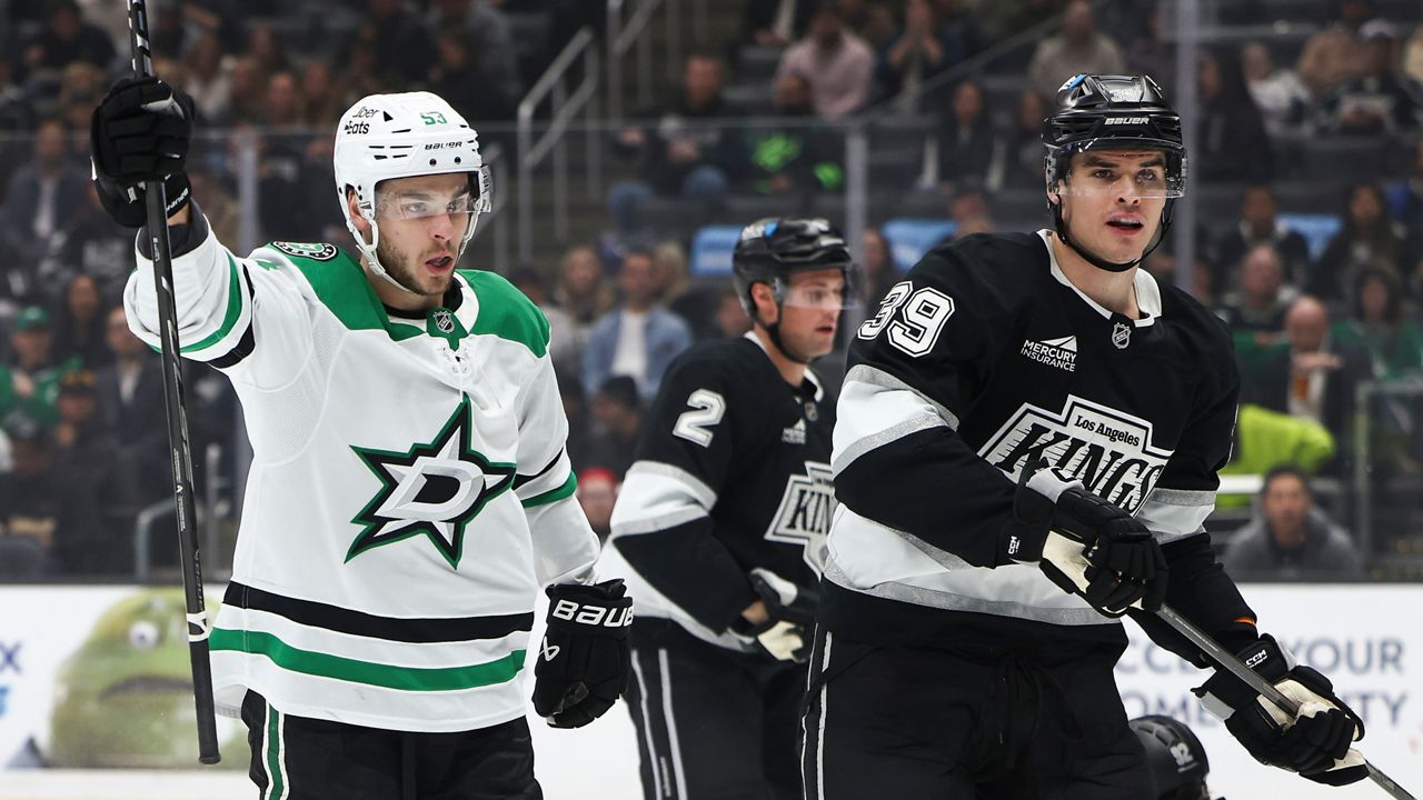 Dallas Stars center Wyatt Johnston, left, celebrates after scoring as Los Angeles Kings defenseman Brian Dumoulin (2) and left wing Jeff Malott (39) look on during the first period of an NHL hockey game, Monday, Jan. 12, 2026, in Los Angeles. (AP Photo/Jessie Alcheh)