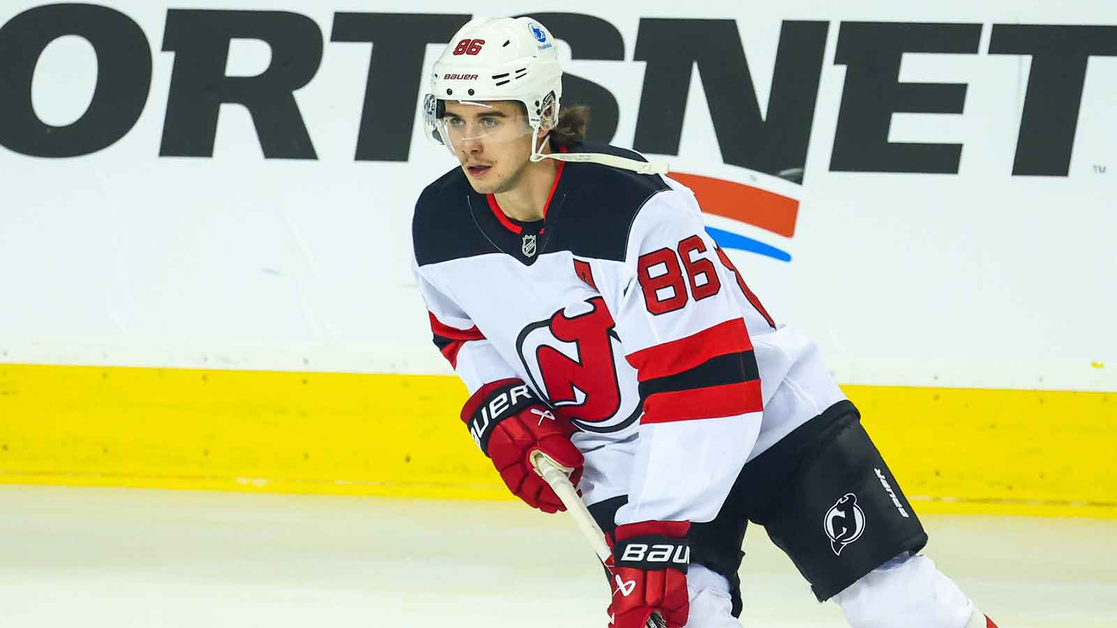 New Jersey Devils center Jack Hughes (86) talks with his brother defenseman Luke Hughes (43) before the start of the third period against the Pittsburgh Penguins at PPG Paints Arena.