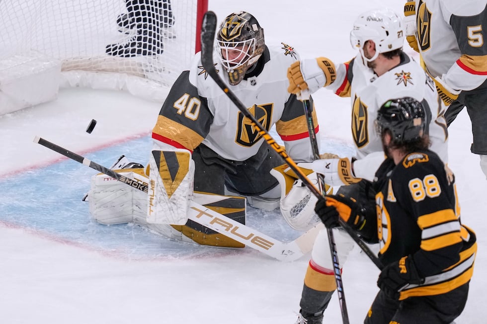 Vegas Golden Knights goaltender Akira Schmid (40) looks at the puck on a goal by Boston Bruins...