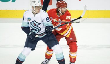 Surging Kraken score four times in third period to burn Flames