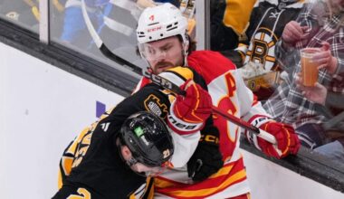Calgary Flames defenseman Rasmus Andersson (4) tangles with Boston Bruins center Alex Steeves (21) during the first period of an NHL hockey game, Thursday, Jan. 8, 2026, in Boston.