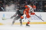 Seattle Kraken right wing Eeli Tolvanen (20) collides with Anaheim Ducks left wing Cutter Gauthier, right, during the third period of an NHL hockey game Friday, Jan. 23, 2026, in Seattle.