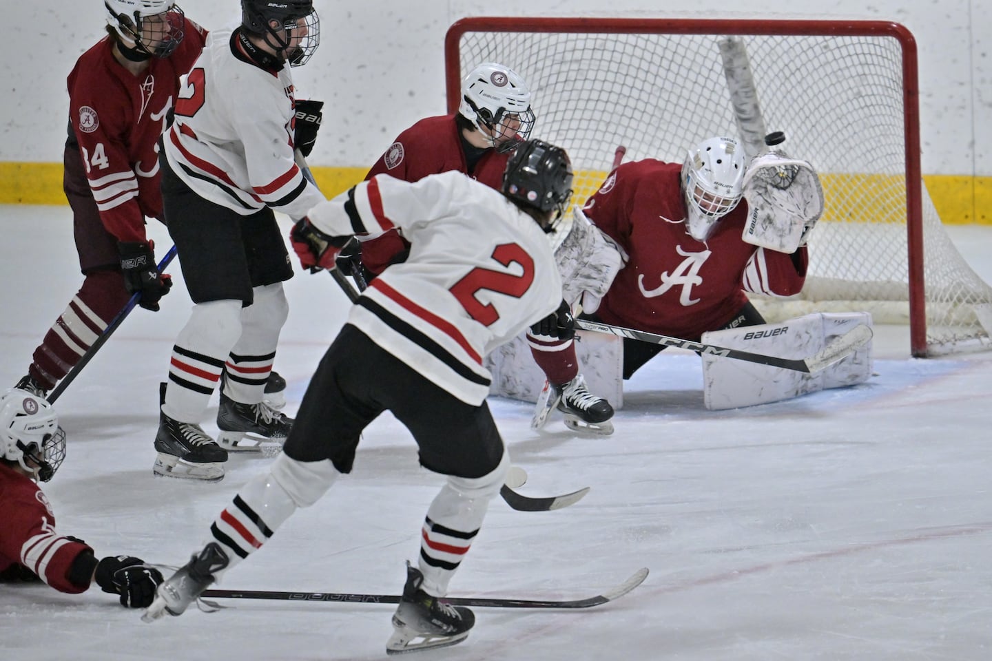 Winchester's Axel Osborn (2) scores a second-period goal on Arlington goalie Chris Displacedo.
