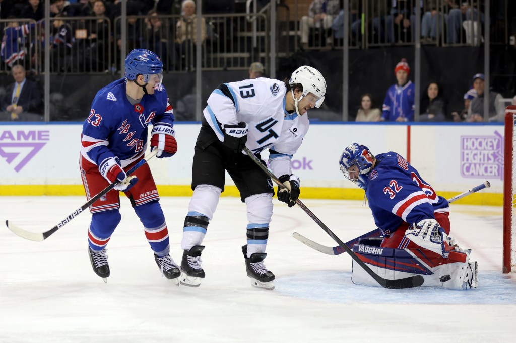 Jonathan Quick makes a save on Brandon Tanev as Adam Fox defends during the Rangers' loss to the Mammoth on Jan. 5, 2025.
