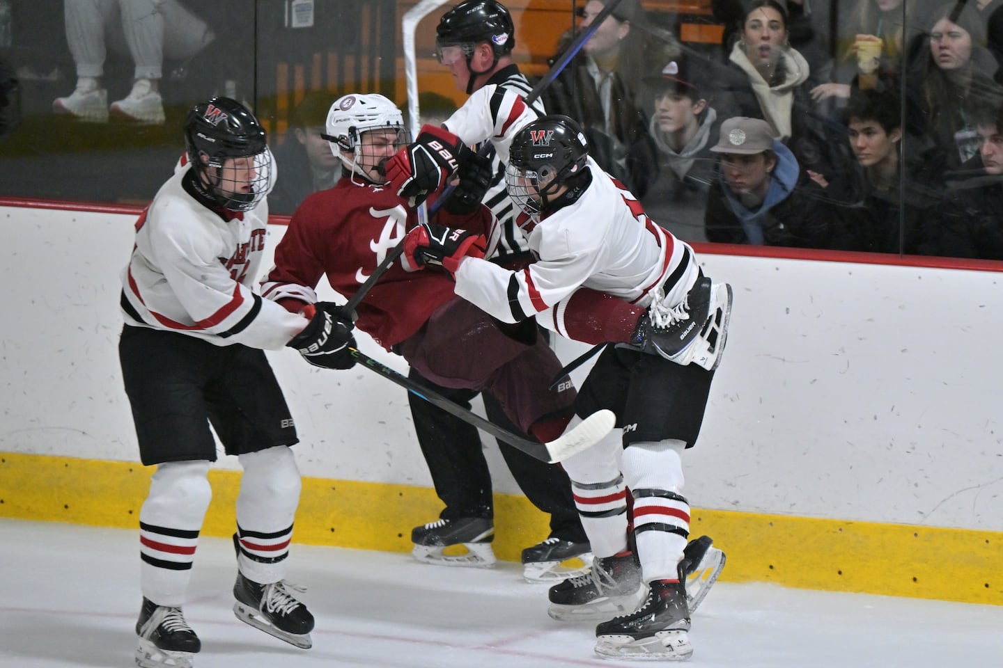 Winchester's Joseph Vaccari lays a big hit on Arlington's Dylan Courtney.