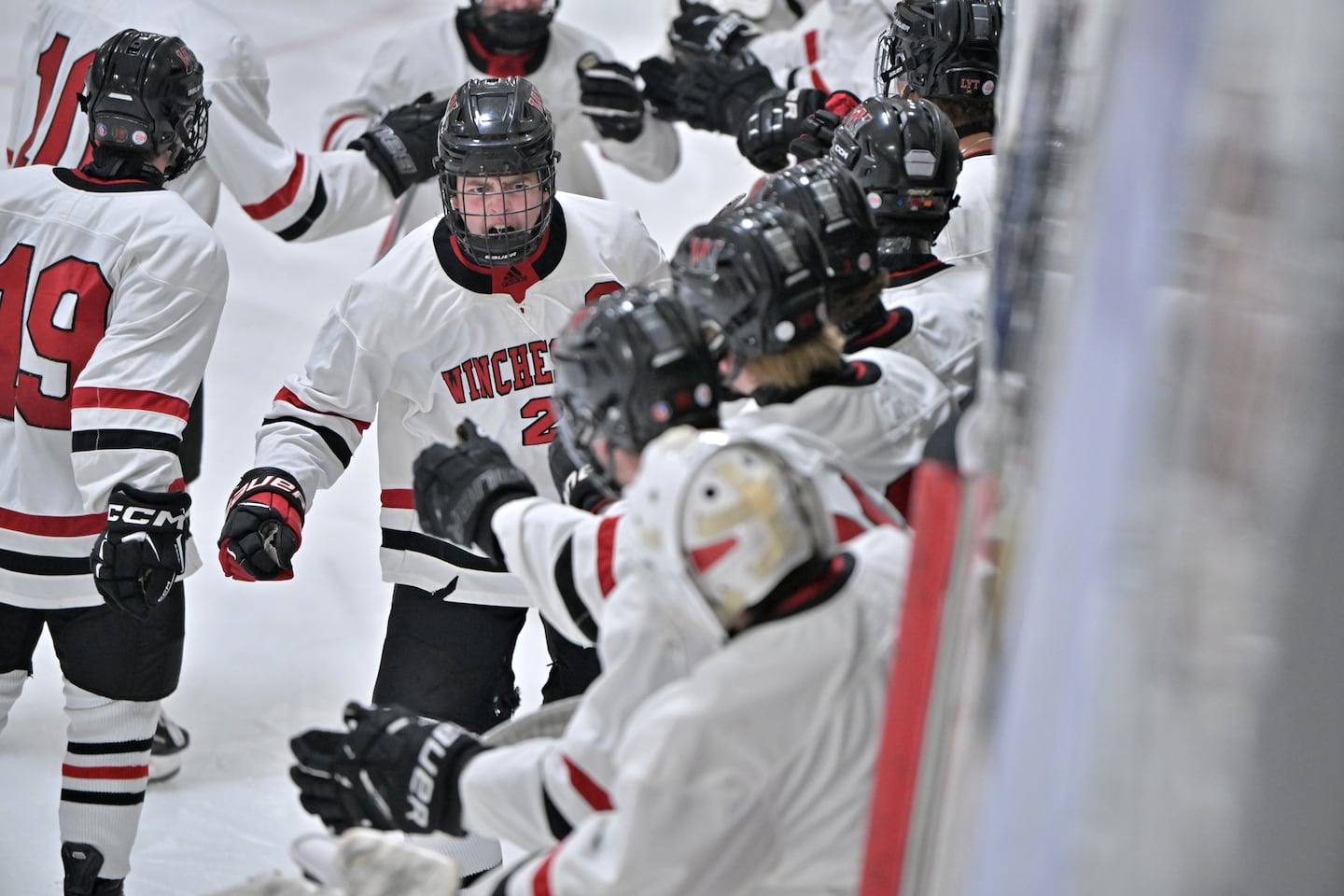 Winchester's Axel Osborn (2) celebrates a second-period goal with his teammates. 