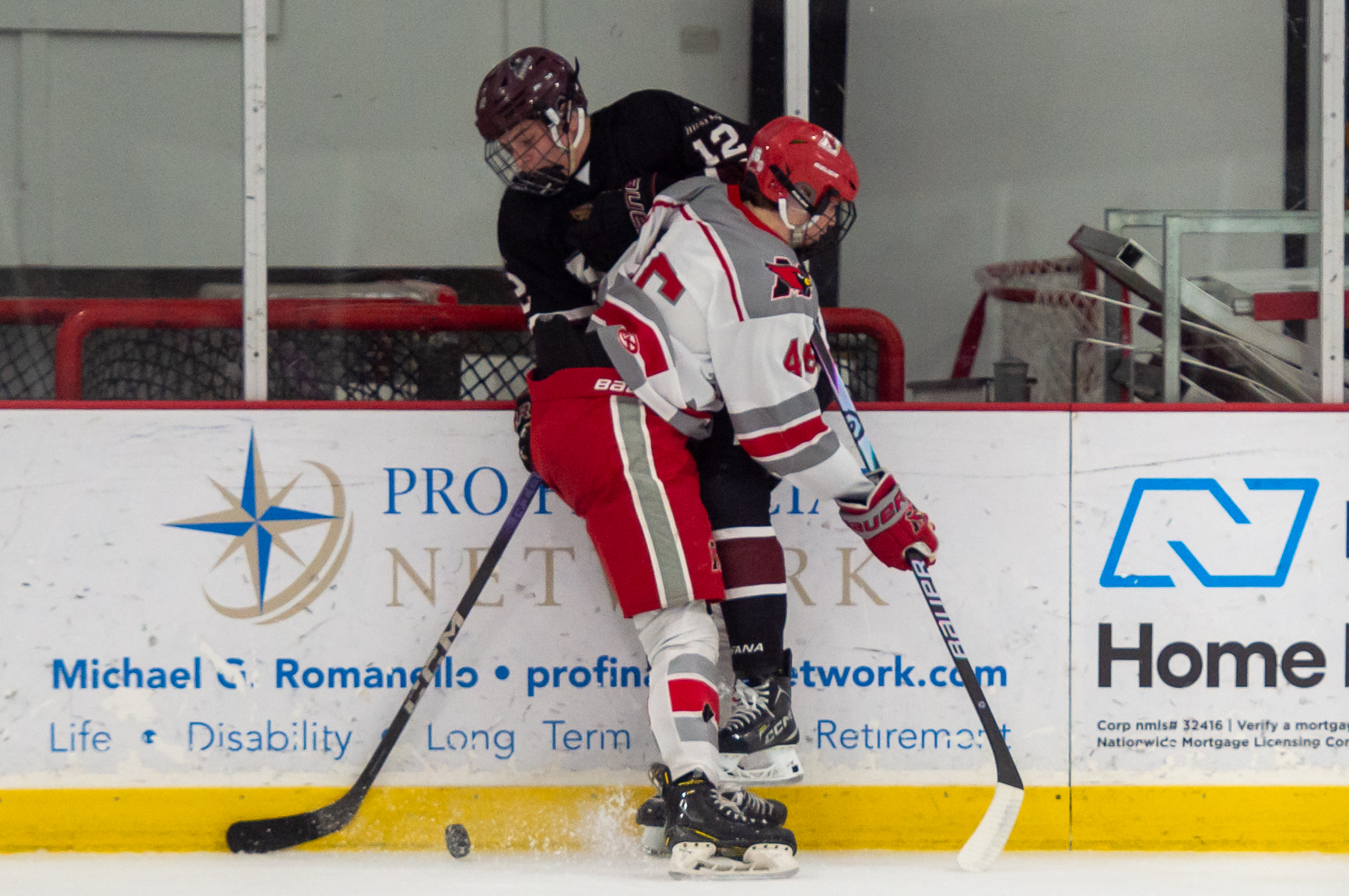Mentor's Adam Stoops checks Rocky River's Colin McDonough on Jan....