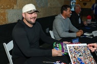 Texas Rangers player Jake Burger signs autographs during the Texas Rangers annual toy drive...