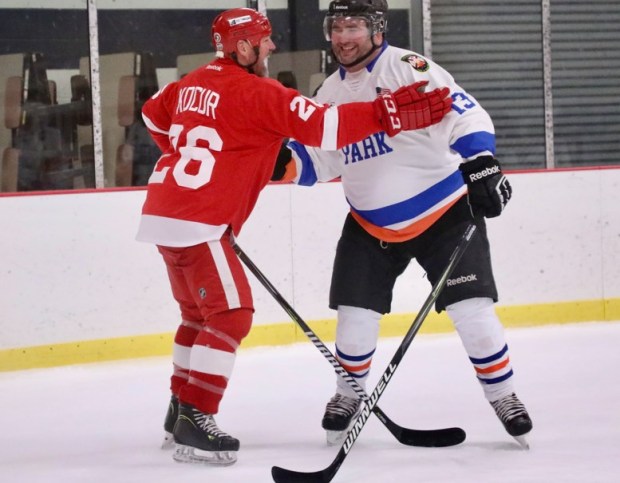 Joey Kocur (25) shares a laugh with an unidentified member of the Lincoln Park team at Saturday's game. (CONSTANCE YORK--For The News-Herald)