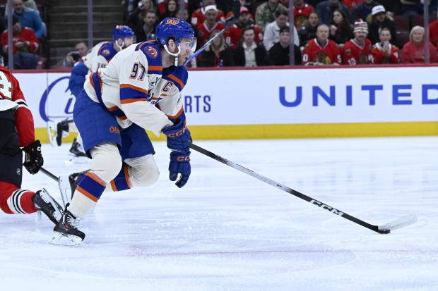 Edmonton Oilers center Connor McDavid (97) moves the puck against the Chicago Blackhawks during the first period of an NHL hockey game, Monday, Jan. 12, 2026, in Chicago. (AP Photo/Matt Marton)
