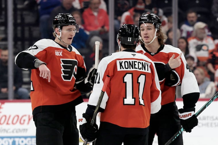Flyers # 22 Christian Dvorak, # 11 Travis Konecny and # 46 Trevor Zegras gather during a stoppage in play during the New York Rangers vs. Philadelphia Flyers NHL game at Xfinity Mobile Arena in Philadelphia on Saturday, Jan. 17, 2026.