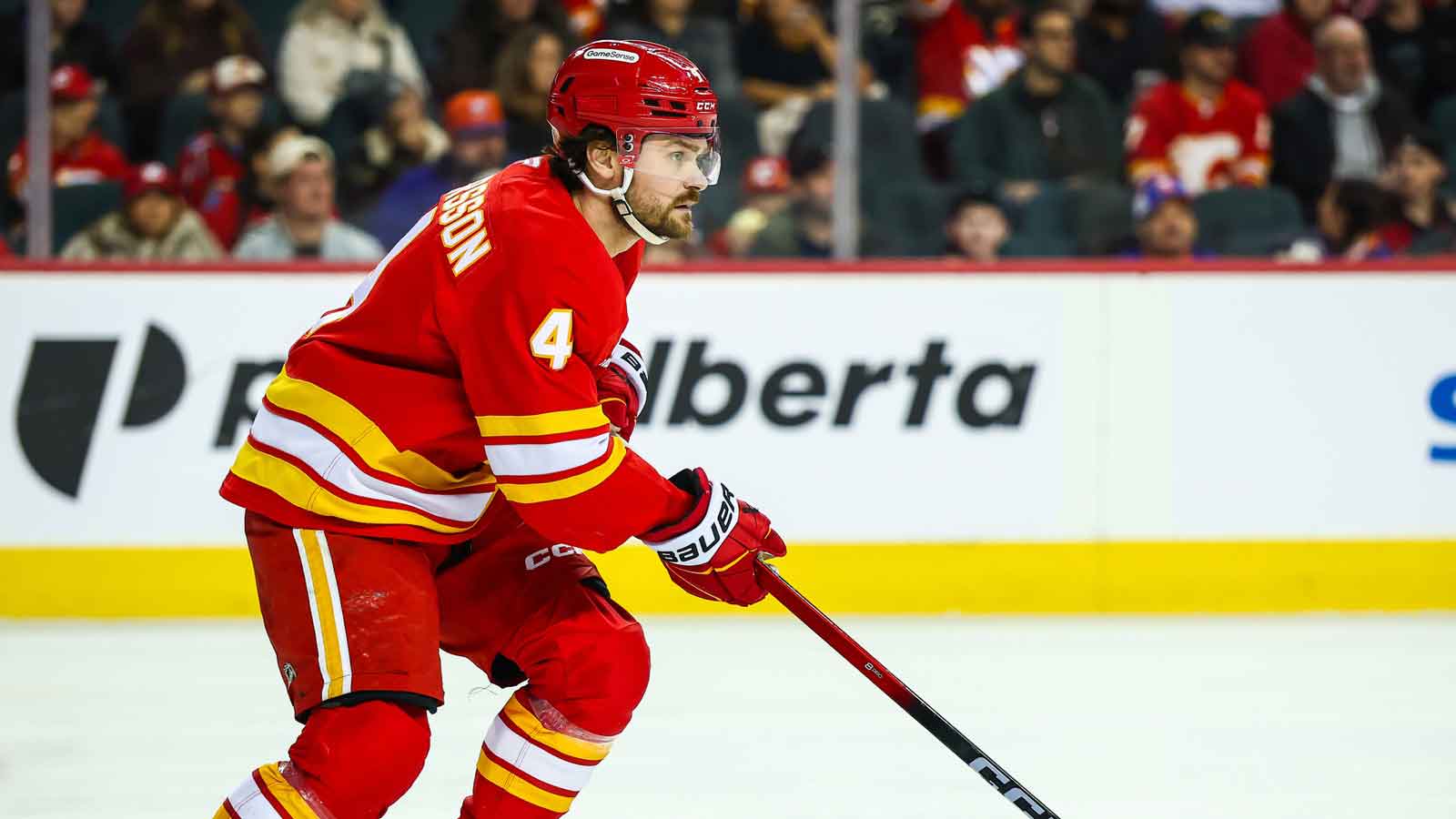 Calgary Flames defenseman Rasmus Andersson (4) skates with the puck against the New York Islanders during the third period at Scotiabank Saddledome.