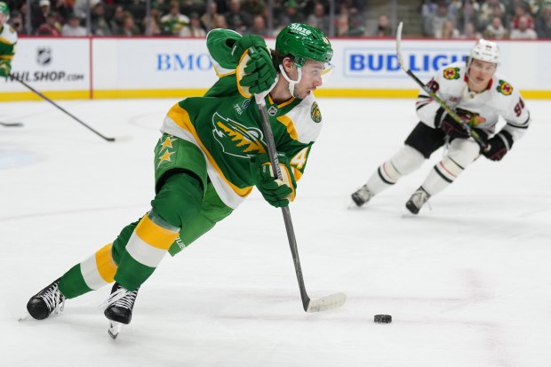 Minnesota Wild defenseman Quinn Hughes (43) brings puck up ice