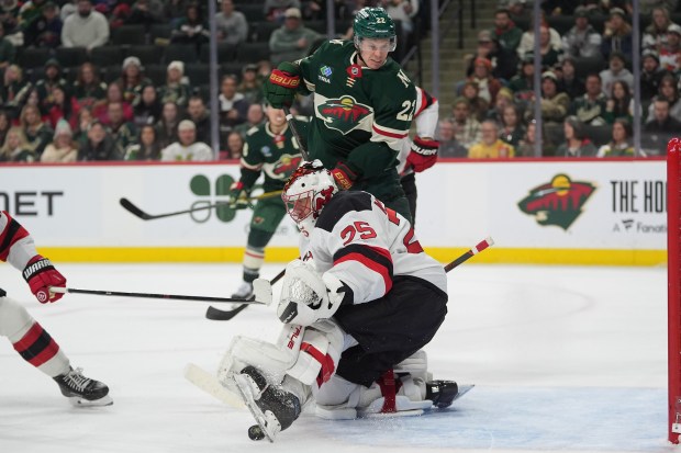 Danila Yurov harasses the Devils goalie
