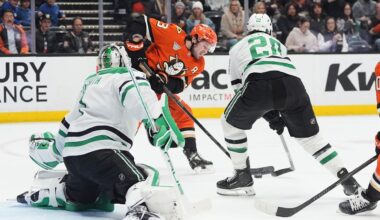 Anaheim Ducks center Mason McTavish, center, shoots as Dallas Stars goaltender Casey DeSmith, left, and defenseman Alexander Petrovic defend during the first period of an NHL hockey game Tuesday, Jan. 13, 2026, in Anaheim, Calif. (AP Photo/Gregory Bull)