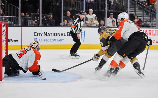 Flyers goalie Samuel Ersson #33 blocks a backhand shot by Vegas' Reilly Smith with the top of his stick as Travis Sanheim defends in the second period of their game at T-Mobile Arena on January 19, 2026 in Las Vegas, Nevada. The Flyers defeated the Golden Knights 2-1. (Photo by Ethan Miller/Getty Images)
