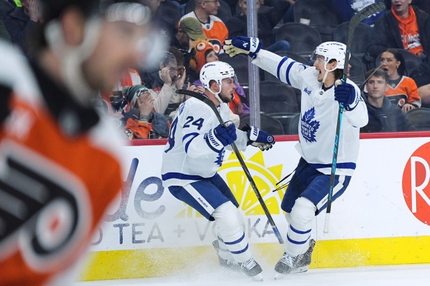Toronto Maple Leafs' Scott Laughton (24) celebrates after his goal against the Philadelphia Flyers with teammate Philippe Myers during the third period of an NHL hockey game, Thursday, Jan. 8, 2026, in Philadelphia. (AP Photo/Matt Rourke)