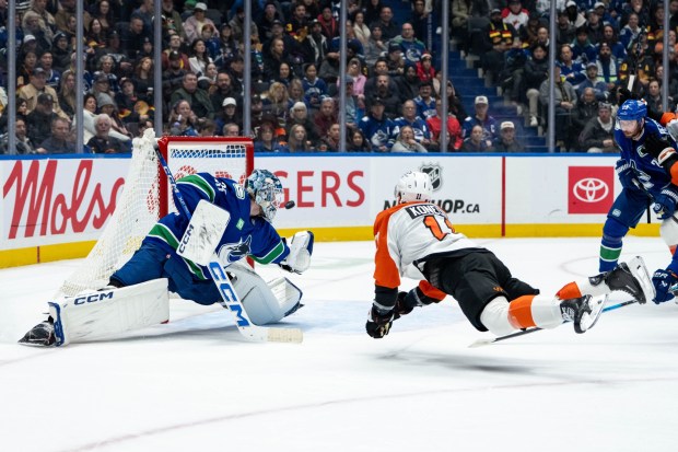 The Flyers' Travis Konecny scores on Canucks goaltender Thatcher Demko on Dec. 20, 2025, in Vancouver, B.C. Konecny had 13 goals and 23 assists heading into the weekend. (Ethan Cairns/The Canadian Press via AP)