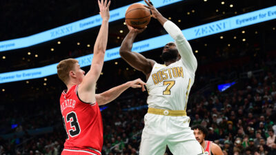 Jan 5, 2026; Boston, Massachusetts, USA; Boston Celtics guard Jaylen Brown (7) shoots the ball while Chicago Bulls guard Kevin Huerter (13) defends during the first half at TD Garden.