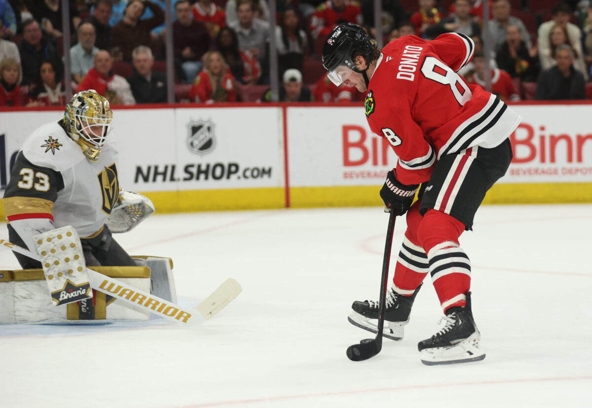 Mar 28, 2025; Chicago, Illinois, USA; Chicago Blackhawks center Ryan Donato (8) scores on Vegas Golden Knights goaltender Adin Hill (33) during the first period at United Center. Mandatory Credit: Talia Sprague-Imagn Images