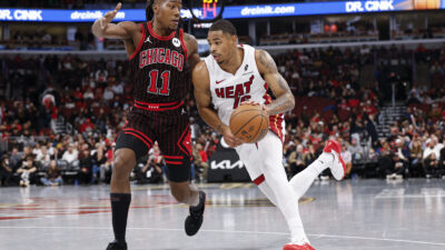 Nov 21, 2025; Chicago, Illinois, USA; Miami Heat forward Keshad Johnson (16) drives to the basket against Chicago Bulls guard Ayo Dosunmu (11) during the second half at United Center. Mandatory Credit: Kamil Krzaczynski-Imagn Images