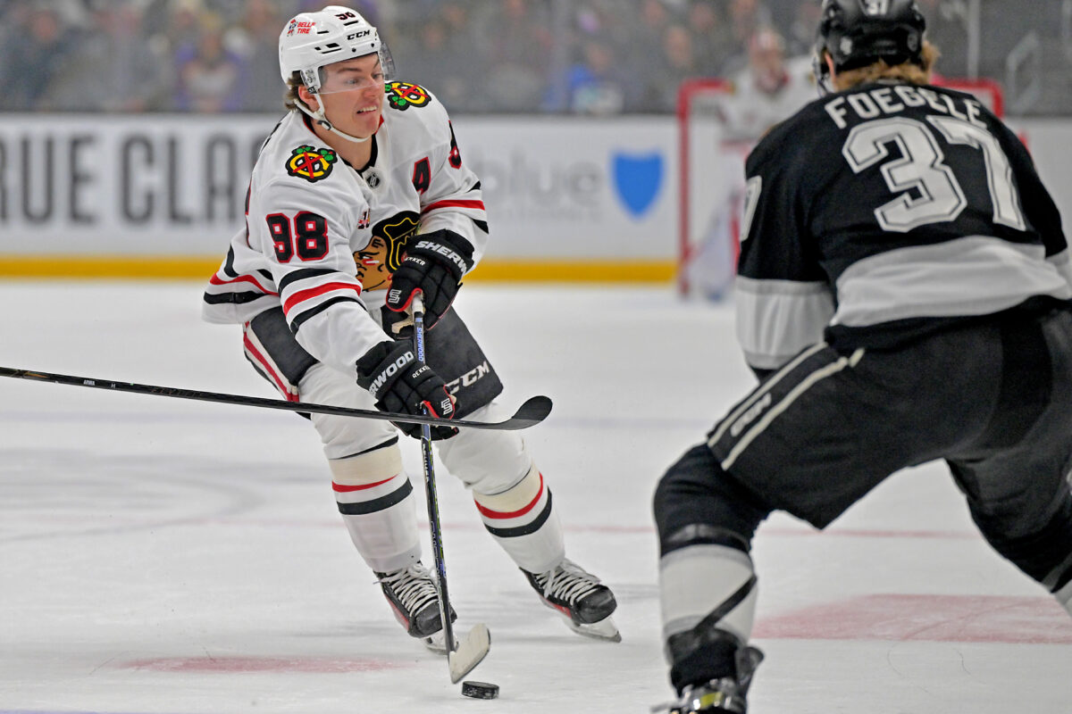 Dec 4, 2025; Los Angeles, California, USA; Chicago Blackhawks center Connor Bedard (98) has a shot defended by Los Angeles Kings left wing Warren Foegele (37) during the first period at Crypto.com Arena. Mandatory Credit: Jayne Kamin-Oncea-Imagn Images