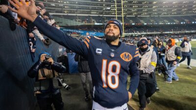 Chicago Bears quarterback Caleb Williams (18) high fives fans after their game Saturday, December 20, 2025 at Soldier Field in Chicago, Illinois. The Chicago Bears beat the Green Bay Packers 22-16 in overtime.