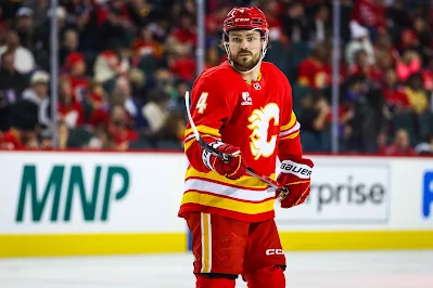 Calgary Flames defenseman Rasmus Andersson reacts during 2025 game.