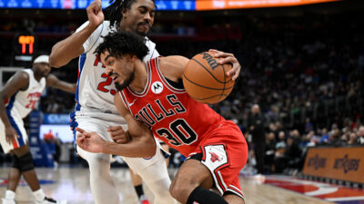 Jan 7, 2026; Detroit, Michigan, USA; Chicago Bulls guard Tre Jones (30) drives to the basket against Detroit Pistons guard Jaden Ivey (23) in the third quarter at Little Caesars Arena. Mandatory Credit: Lon Horwedel-Imagn Images