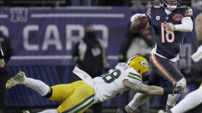 Jan 10, 2026; Chicago, IL, USA; Chicago Bears quarterback Caleb Williams (18) avoids a tackle by Green Bay Packers linebacker Isaiah McDuffie (58) during the fourth quarter of an NFC Wild Card Round game at Soldier Field