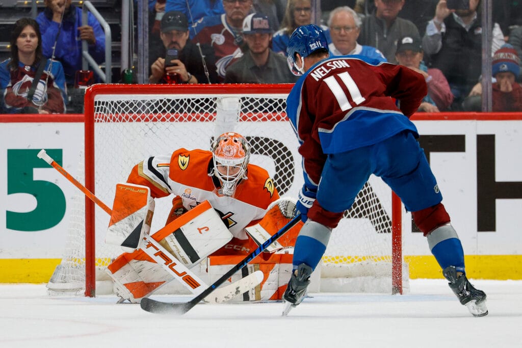 Colorado Avalanche center Brock Nelson (11) controls the puck as Anaheim Ducks goaltender Lukas Dostal (1) defends in the shootout at Ball Arena. Mandatory Credit: Isaiah J. Downing-Imagn Images
