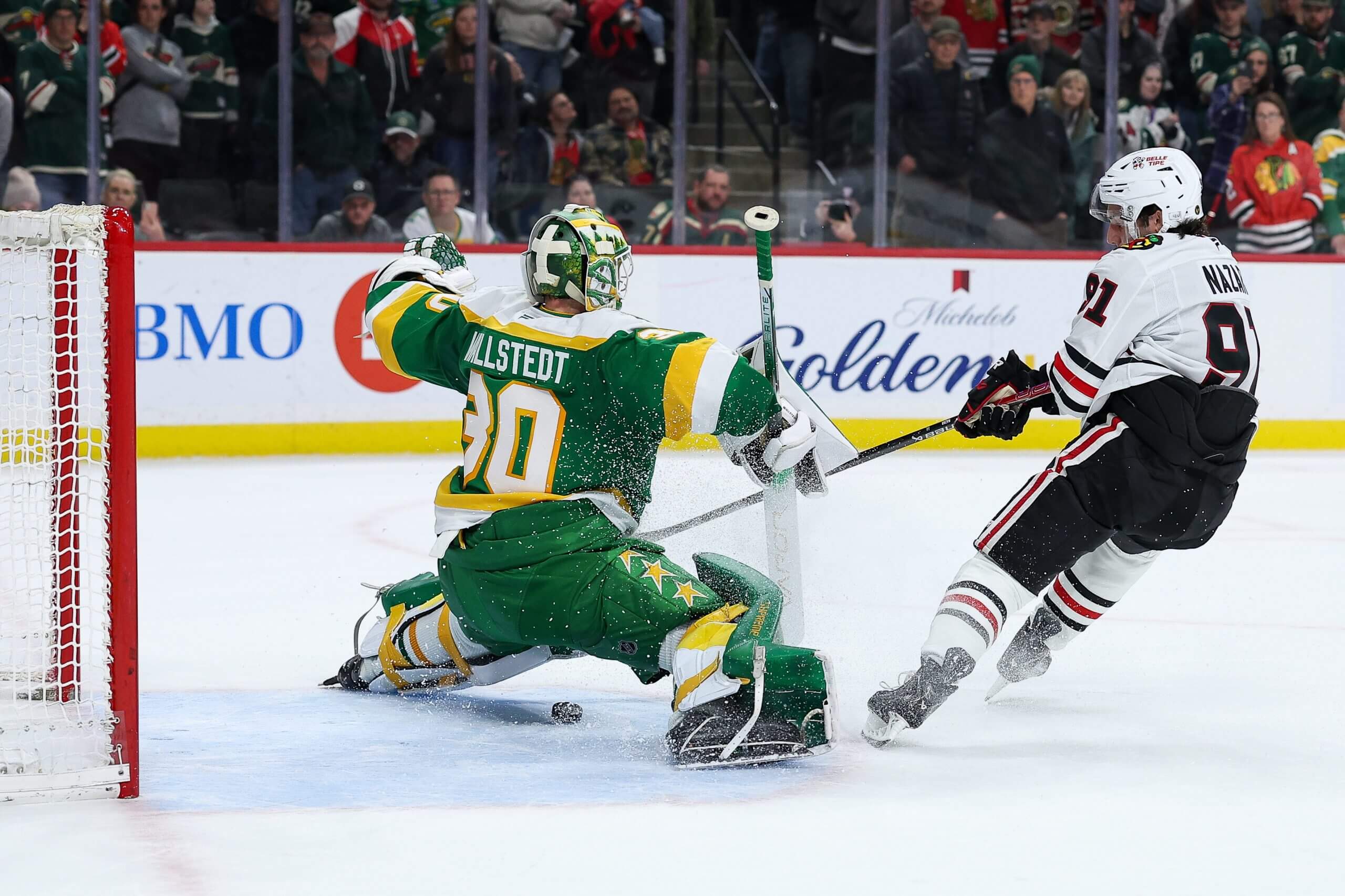 Frank Nazar, right, shoots the puck between Wild goalie Jesper Wallstedt's legs, left, in the shootout.