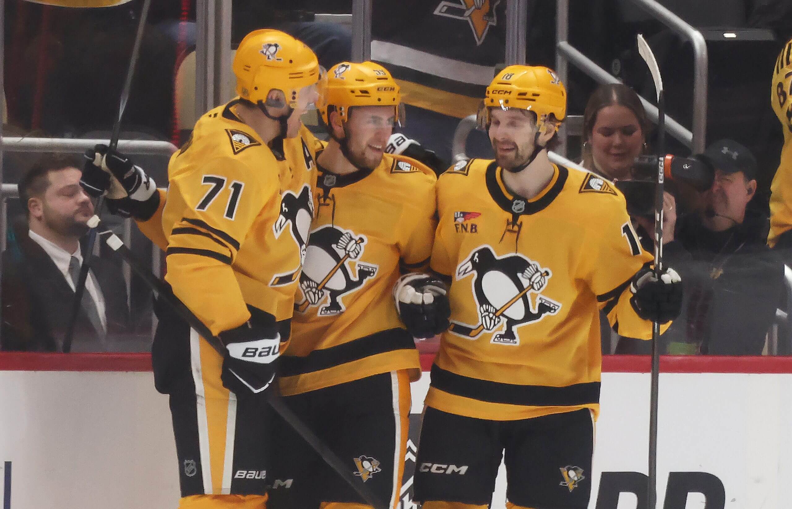 Evgeni Malkin and Tommy Novak congratulate Egor Chinakhov on his second-period goal.