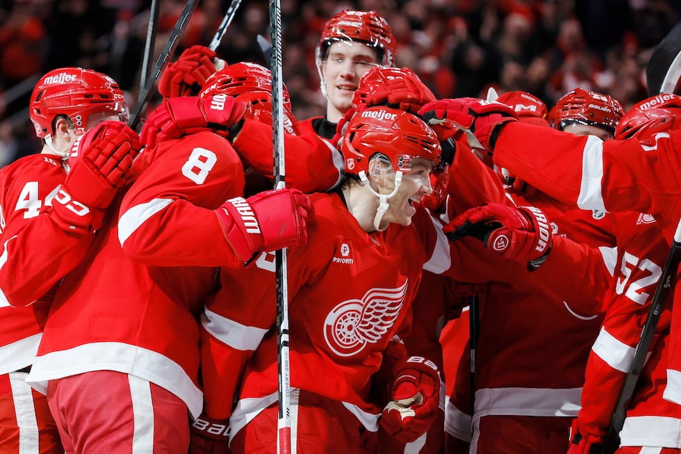 Detroit Red Wings right wing Patrick Kane, center, is surround by teammates after recording...