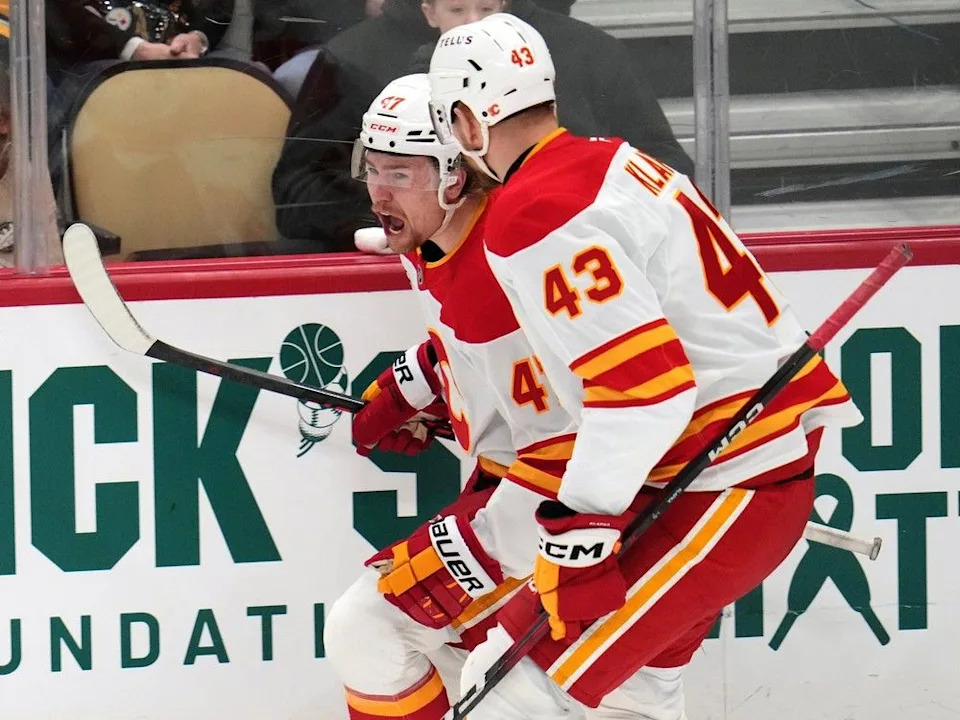  Flames forward Connor Zary (back) celebrates his goal against the Penguins with Adam Klapka.