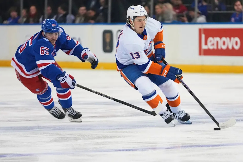 New York Islanders’ Mathew Barzal (13) deke past New York Rangers’ Brett Berard (65) during the first period of an NHL hockey game Thursday, Jan. 29, 2026, in New York. AP