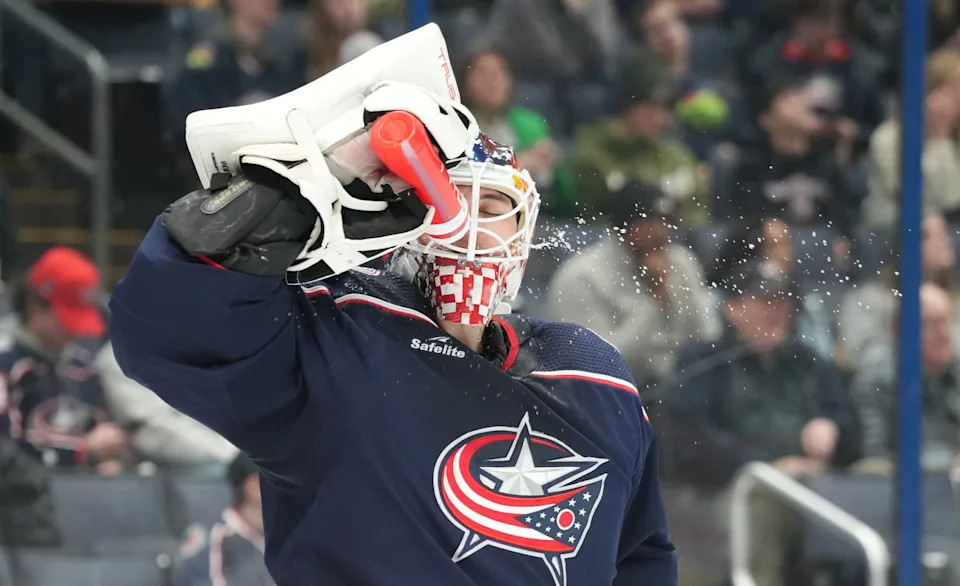 Blue Jackets goaltender Elvis Merzlikins takes a water break during a game on Feb. 23, 2024.