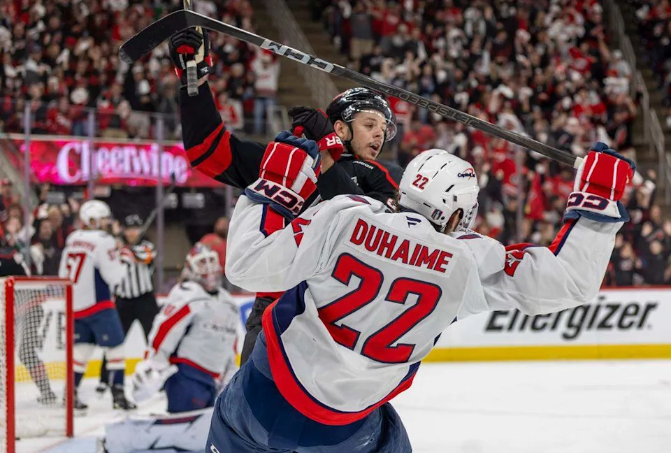 Carolina Hurricanes center Jesperi Kotkaniemi (82) checks Washington Capitals right wing Brandon Duhaime (22) in the first period during Game 4 of their series on Monday, May 12, 2025 at Lenovo Center in Raleigh, N.C.