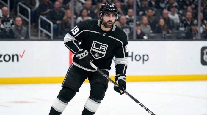 Los Angeles Kings forward Alex Tuch (89) skating on the ice in a black home jersey during an NHL game.
