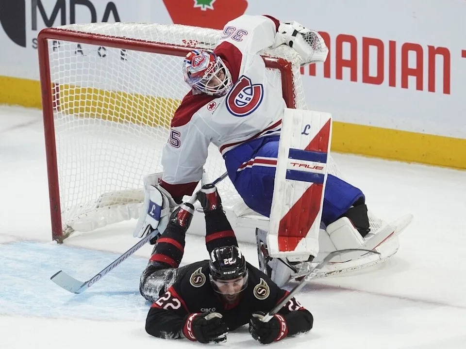  Senators winger Michael Amadio (22) slides into Canadiens netminder Samuel Montembeault, causing him to stumble in the second period.
