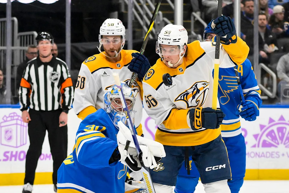 Dec 15, 2025; St. Louis, Missouri, USA; St. Louis Blues goaltender Joel Hofer (30) defends the net against Nashville Predators left wing Michael Bunting (58) and left wing Erik Haula (56) during the first period at Enterprise Center. Mandatory Credit: Jeff Curry-Imagn Images