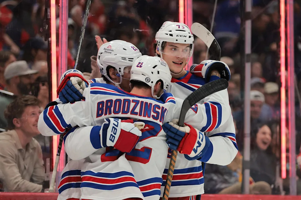 Apr 14, 2025; Sunrise, Florida, USA; New York Rangers center Jonny Brodzinski (22) celebrates with left wing Chris Kreider (20) and center Matt Rempe (73) after scoring against the Florida Panthers during the third period at Amerant Bank Arena. Mandatory Credit: Sam Navarro-Imagn Images