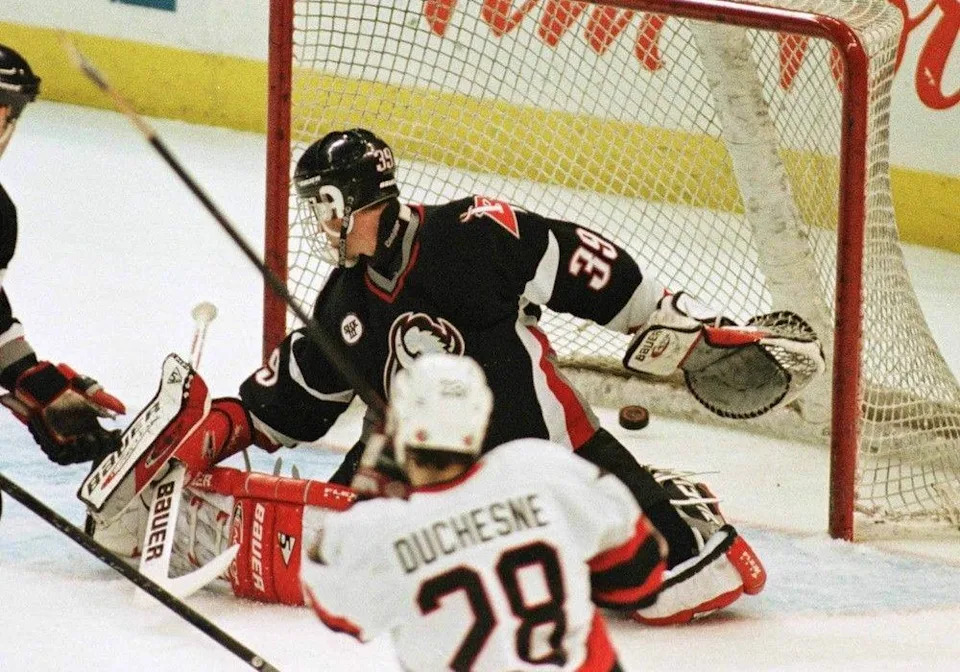 Defenceman Steve Duchesne scores a goal against Buffalo Sabres netminder Dominik Hasek in the third period of a game on April 12, 1997, to put the Ottawa Senators in the NHL playoffs for the first time.
