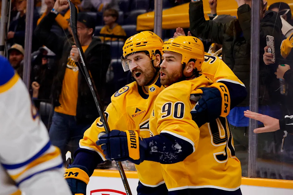 Jan 20, 2026; Nashville, Tennessee, USA; Nashville Predators center Ryan O'Reilly (90) celebrates his goal with left wing Filip Forsberg (9) against the Buffalo Sabres during the third period at Bridgestone Arena. Mandatory Credit: Steve Roberts-Imagn Images