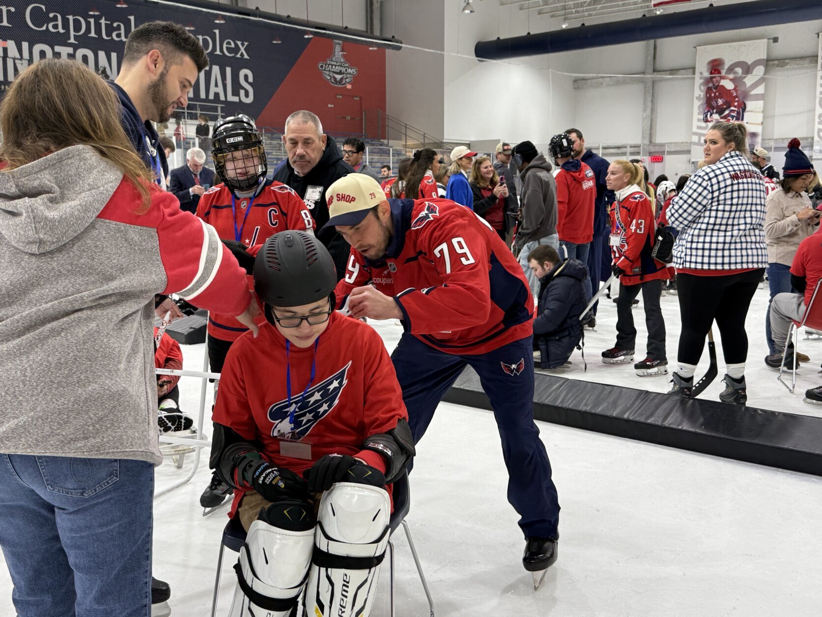Lindgren signs an autograph for a kid on the ice.