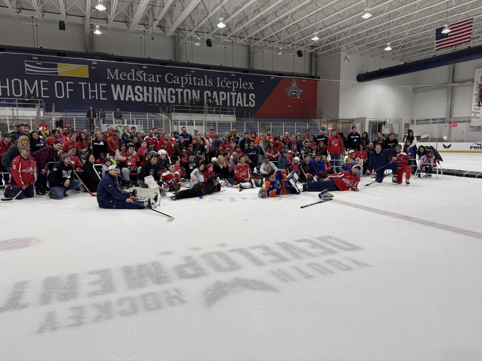 kids with disabilities pose for a group photo with caps players